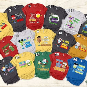 May include: A collection of 16 colorful t-shirts featuring various cartoon characters and humorous sayings related to wine and beer. The shirts are arranged in a grid pattern on a wooden surface.