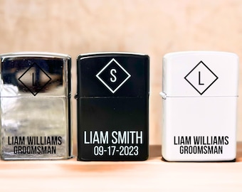 May include: Three silver, black, and white lighters with personalized engravings. The silver lighter says "Liam Williams, Groomsman". The black lighter says "Liam Smith, 09-17-2023". The white lighter says "Liam Williams, Groomsman".