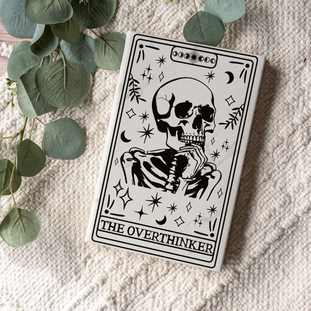 A custom engraved tarot journal with the words 'The Overthinker' on the cover