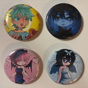 May include: Four round pinback buttons with anime-style illustrations. The buttons feature colorful artwork of characters with various expressions and designs. The buttons are yellow, blue, pink, and light blue.