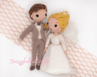 May include: Crocheted bride and groom dolls. The bride is wearing a white dress with a veil and has blonde hair. The groom is wearing a brown suit with a white shirt and bow tie. The dolls are standing on a peach-colored background.