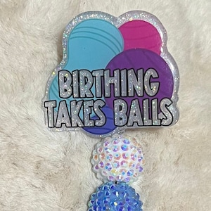 Birth takes balls/Peanut ball badge reel light background