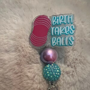 Birth takes balls/Peanut ball badge reel light background
