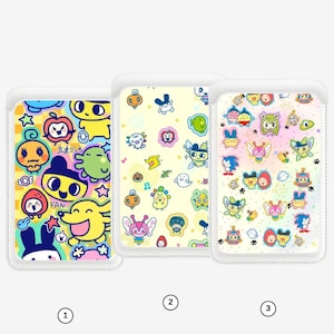 May include: Three phone card holders with colourful cartoon character designs. The first features a yellow background with various characters and the Japanese text "FAN" and "ちまぷち". The second has a light yellow background with multiple cartoon characters. The third has a pastel background with various cartoon characters.