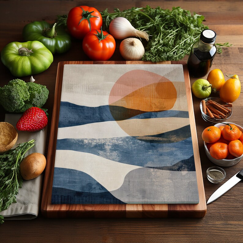 May include: A wooden cutting board with a blue, white, and orange abstract design. The design features a large circle with a pink and orange gradient, and wavy lines in shades of blue.