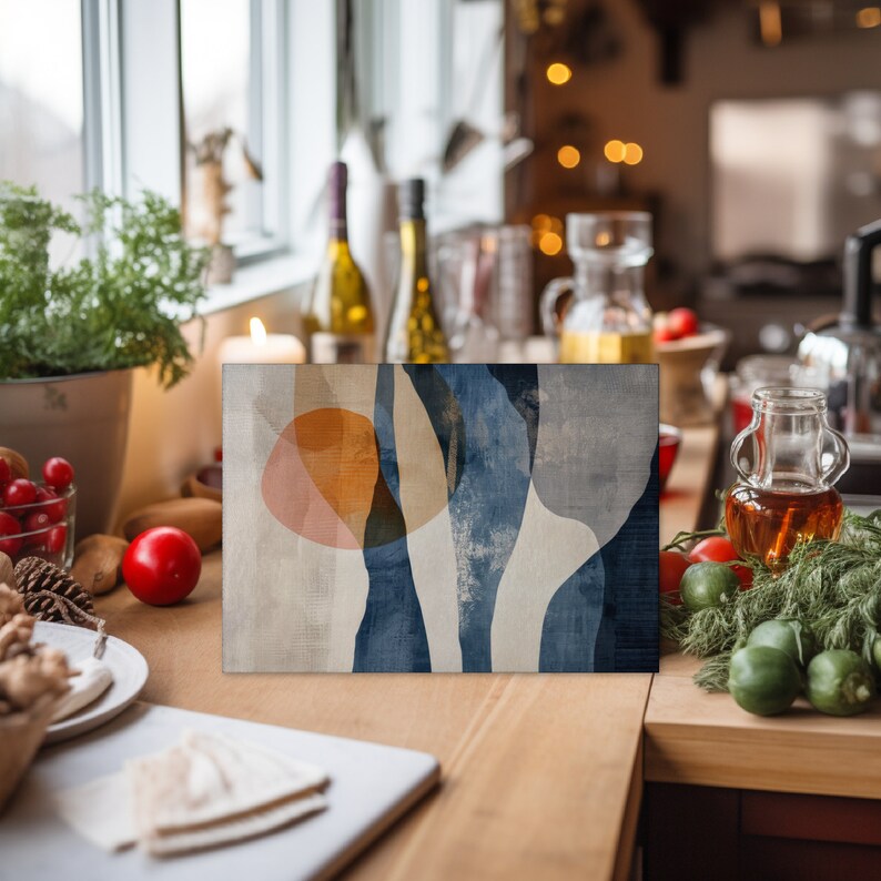 May include: Abstract art print with blue, white, and orange shapes on a textured background. The print is framed and hanging on a wall.