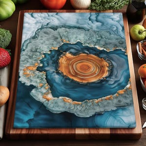 May include: A rectangular cutting board with a unique design. The center features a circular pattern in shades of brown and orange, surrounded by blue and white swirls. The board is set on a wooden base, with various fruits and vegetables around it.