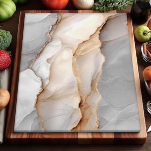 May include: A rectangular chopping board with a marble effect design. The board has white, grey, and gold tones, with a wooden frame. Fresh produce, including tomatoes, oranges, and strawberries, surrounds the board.