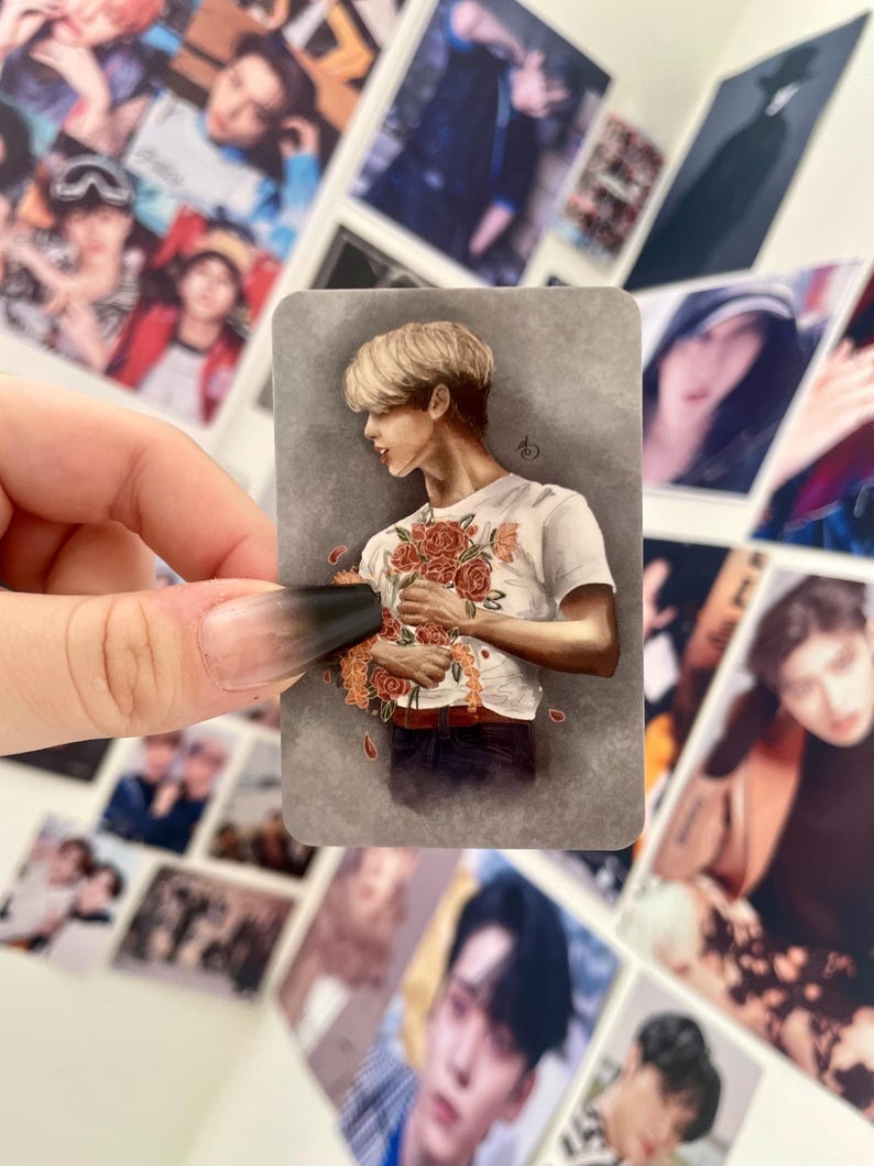 May include: A sticker featuring a drawing of a person with blond hair holding a bouquet of red roses. The person is wearing a white t-shirt with a floral pattern and blue jeans. The background is a gray gradient.