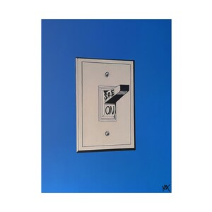 May include: A white light switch with a black toggle switch that is flipped to the "ON" position. The switch is on a blue background.