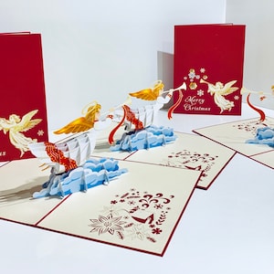 Anjo de Natal tocando trombeta em vermelho ~ Cartão de felicitações pop-up 3D feito à mão com amor Compre online https://origamipopcards.com/