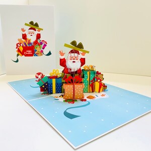Papai Noel com presentes de Natal ~ Cartão de felicitações pop-up 3D Feliz Natal feito à mão Compre online https://origamipopcards.com/