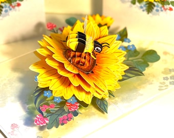 Tarjeta de felicitación 3D emergente con un abejorro que atrae girasoles. Feliz cumpleaños. Tarjetas pop-up de origami hechas a mano. Compra en línea: https://origamipopcards.com/