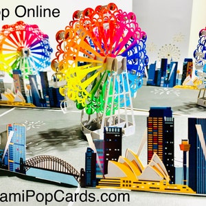 Cartão de roda gigante com arco-íris e vista da cidade criado por Origami Pop Cards, Sydney, Austrália. Cartões pop-up de papel 3D OrigamiPopCards.com feitos à mão.