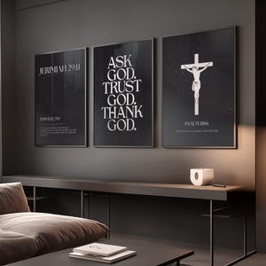 May include: Three framed black and white wall art prints. The first print reads "JERIMIAH 29:11" and includes text below. The second print says "ASK GOD. TRUST GOD. THANK GOD." The third print features a crucifix and the text "PSALM 118:6".
