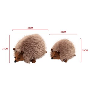 May include: Two plush hedgehog toys. The larger hedgehog is 15 inches long and 12 inches tall. The smaller hedgehog is 12 inches long and 7.5 inches tall. Both have brown bodies and soft, textured fur.