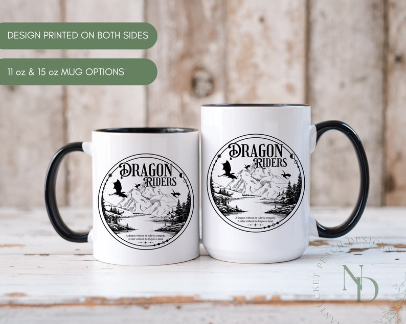May include: Two white ceramic mugs with black handles and black rims. Both mugs feature a black and white illustration of a dragon with the text "Dragon Riders" in a circle. The text below the circle reads "A dragon without a rider is simply a rider without a dragon is dead."