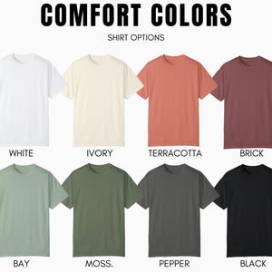 May include: A selection of t-shirts in various colors, including white, ivory, terracotta, brick, bay, moss, pepper, and black. The shirts are all plain and have a crew neck. The text "COMFORT COLORS" and "SHIRT OPTIONS" is displayed above the shirts.