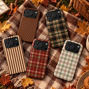 May include: Five rectangular smartphone cases featuring distinct patterns: a brown case with white polka dots, a dark green and black plaid case, a brown and cream striped case, a red and green plaid case, and a cream and sage green gingham case.