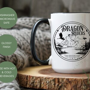 May include: White ceramic mug with a black handle and a black rim. The mug features a black and white illustration of a dragon and the text "Dragon Riders". The text below the illustration reads "A dragon without its rider is a tragedy. A rider without its dragon is dead."