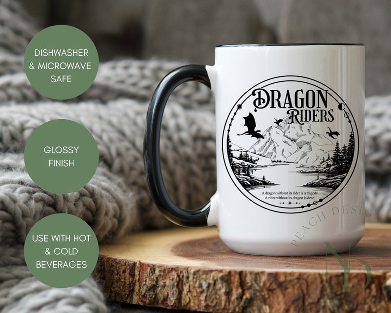 May include: White ceramic mug with a black handle and a black rim. The mug features a black and white illustration of a dragon and the text "Dragon Riders". The text below the illustration reads "A dragon without its rider is a tragedy. A rider without its dragon is dead."