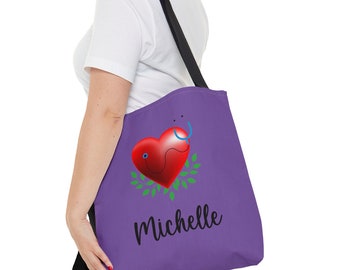 May include: Purple tote bag with a red heart, a blue stethoscope, and green leaves. The name "Michelle" is printed in black below the heart.