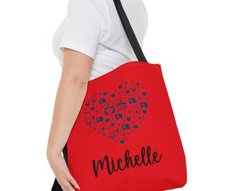May include: Red tote bag with a heart-shaped design made up of blue medical icons. The bag has black straps and the name "Michelle" is printed in black at the bottom.