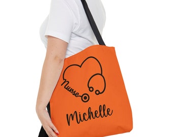 May include: Orange tote bag with black straps and a black graphic of a stethoscope and heart with the text "Nurse Michelle".