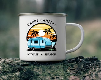 May include: White enamel camping mug featuring a blue camper van illustration and the text "Happy Campers" in a circle with palm trees and a sunset. The text "Michelle ♥ Brandon" is below the illustration.