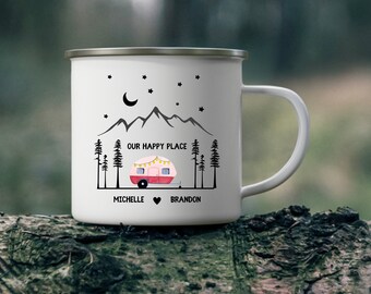 May include: White enamel camping mug featuring a black silhouette of mountains, a camper, and trees. The text "Our Happy Place" is printed on the mug, along with the names "Michelle" and "Brandon" and a heart symbol.