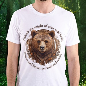 May include: White t-shirt with a brown bear graphic and the text "Unleash the might of your wild heart, fearless and fierce, yet wise and tender."