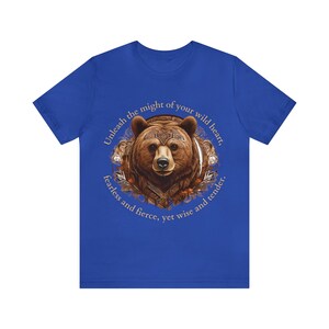 May include: A blue t-shirt with a brown bear illustration and the text "Unleash the might of your wild heart, fearless and fierce, yet wise and tender."