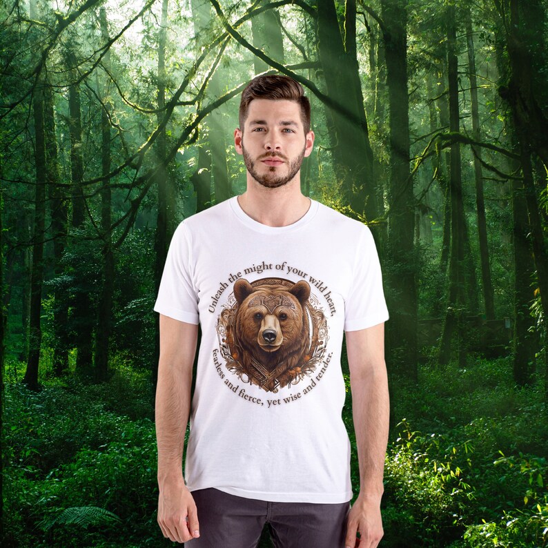 May include: White t-shirt with a brown bear graphic and the text "Unleash the might of your wild heart, fearless and fierce, yet wise and tender."