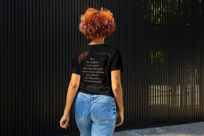 May include: A black t-shirt with a brown text design that reads "May the mighty bear's spirit illuminate the path to your inner wisdom and unleash the full power of your potential."
