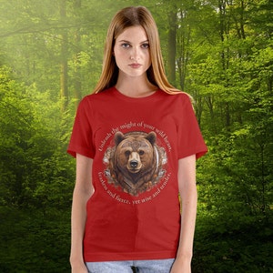 May include: Red t-shirt with a brown bear graphic and the text "Unleash the might of your wild heart. Fearless and fierce, yet wise and tender."