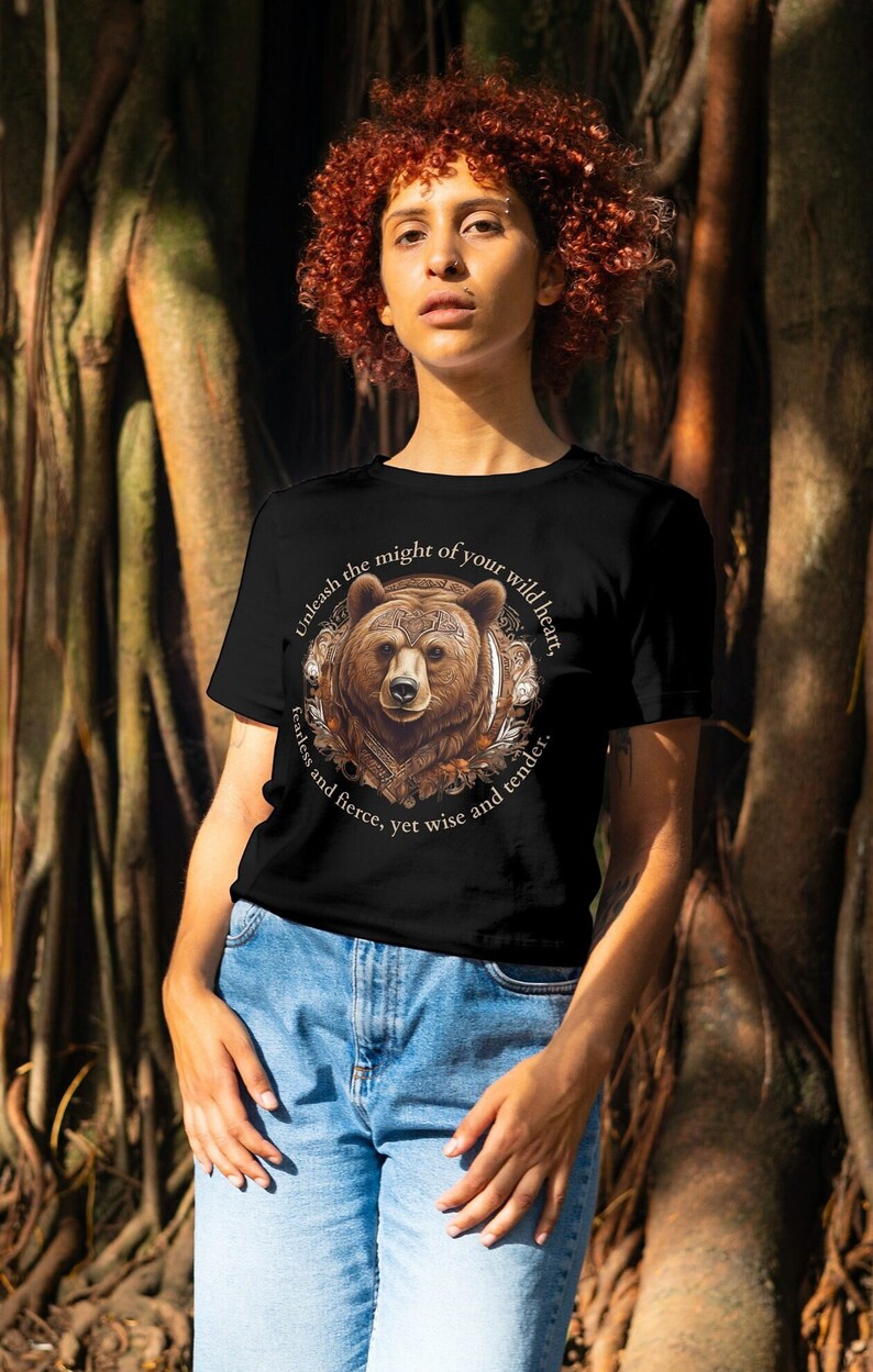 May include: Black t-shirt with a brown bear illustration and the text "Unleash the might of your wild heart, fearless and fierce, yet wise and tender."