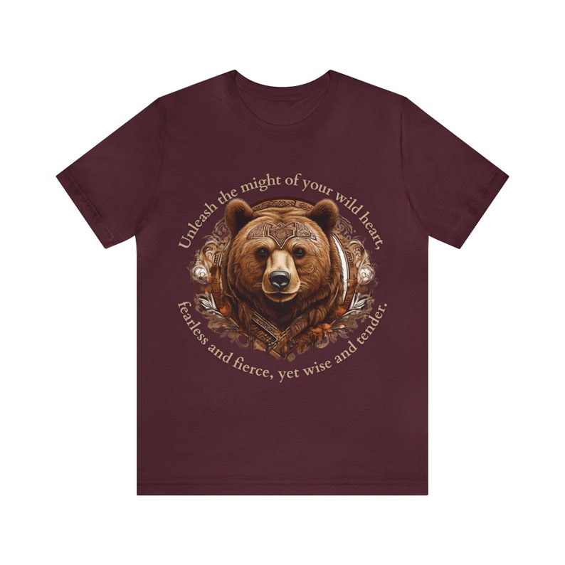 May include: A maroon t-shirt with a brown bear illustration and the text "Unleash the might of your wild heart, fearless and fierce, yet wise and tender."