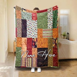 May include: A patchwork quilt with a variety of autumn-themed patterns and colors, including leaves, stripes, and textured designs. The quilt features the text "Name Here" in a cursive font.