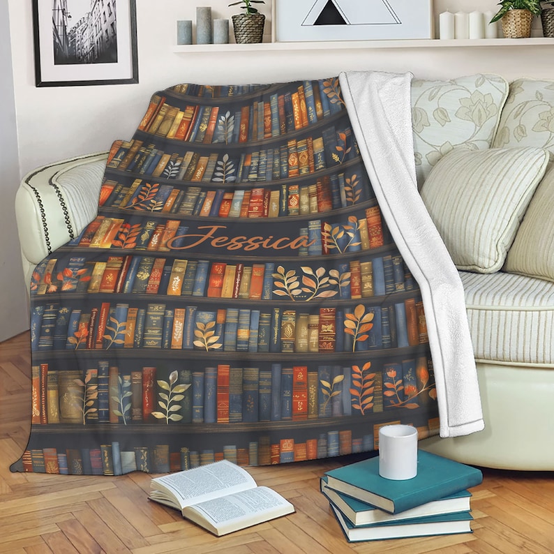 May include: A soft, plush throw blanket with a bookshelf design featuring a variety of colorful books. The blanket is personalized with the name "Jessica" in a cursive font.