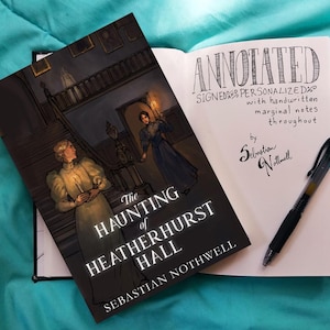 May include: An open book with handwritten notes and a pen next to a book titled "The Haunting of Heatherhurst Hall" by Sebastian Nothwell. The cover art depicts a woman holding a candle in a dark hallway.