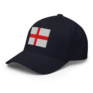 May include: A navy blue baseball cap featuring the flag of England embroidered on the front. The flag is a red cross on a white background. The cap has a curved brim and a structured fit.