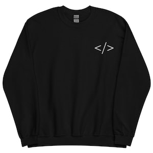 May include: Black sweatshirt with a white embroidered coding symbol on the upper left chest. The sweatshirt has a crew neck and long sleeves. The Gildan brand tag is visible at the back of the neck.
