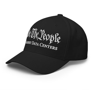 May include: A black baseball cap featuring white embroidered text on the front. The text reads We The People in a stylized gothic font, with the words AGAINST DATA CENTERS printed in a clean, sans-serif capital font directly underneath.
