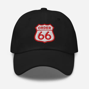 May include: Black baseball cap with a red and white embroidered patch. The patch features a road sign design with the words "ORDER" above the number "66". The cap has a curved brim and an adjustable strap.