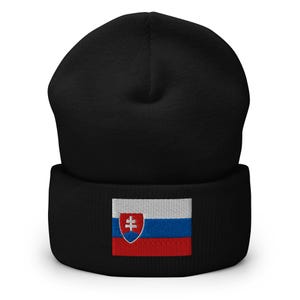 May include: Black beanie hat with the flag of Slovakia embroidered on the front. The flag features a white, blue, and red horizontal stripe design with a coat of arms on the left side.
