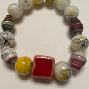 Uganda Recycled Paper Bead Bracelet, With Yellow Splatter Glass Beads And Porcelain Center Charm.