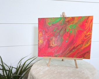 Bright neon colored painting fluid art on canvas panel