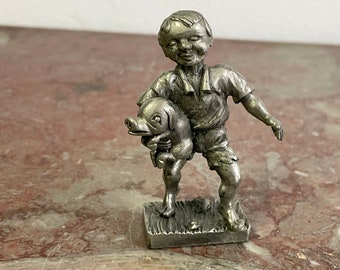 Statuette metal boy with pig. Made in Germany marked. 6.5 cm / 2.6 inches In good condition