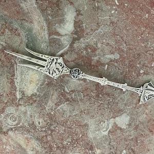 Cheese or charcuterie fork with peace dove and boat motif. Silver plated. Marked. Approx. 17.5 cm length (7 inches). In good condition
