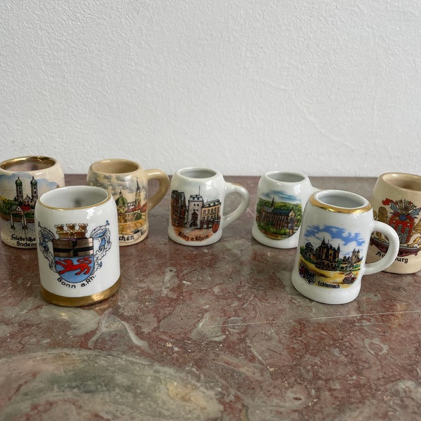 Set/7 miniature beer mugs from Germany. 7 different ones together for 1 price. See pictures. Approx. 5cm high. Souvenir ceramics 1960s-1990s